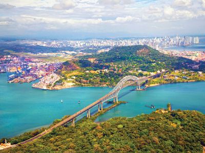 Aerial view of the Bridge of the Americas at the Pacific entrance to the Panama Canal with Panama City in the background.