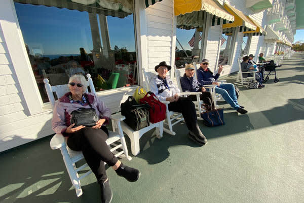 Guest enjoying the worlds largest porch at Grand Hotel