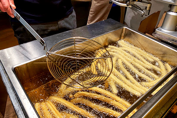 Someone frying churros